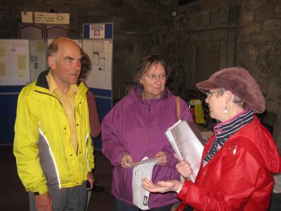 Peter and Val Hawkins listen to Julie Watt's description of the paper-makers' graves in the kirkyard